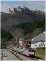 Serie 4000 4013 is hauling a local train through Michelau with the castle of Bourscheid in the background on March 29th, 2009.
