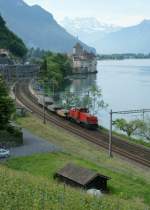 An Am 841 with a short Cargo train by the castle of Chillon.