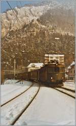 The Re 4/4 I 10039 is approaching Moutier. 
17.01.1985