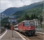 The SBB Re 4/4 II 11245 with an IR to Locarno by his stop in Faido.