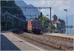 Comming out of the shadow: The SBB Re 420 266-9 with a Carog Train by the Castle of Chillon.