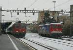 Re 4/4 II with RE to Lausanne and Ae 6/6 in Renens VD.
21.12.2009