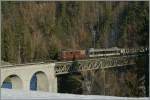 The BLS Re 4/4 192  Spiez  with a RE on the Bunschenbach-Bridge.
05.12.2013