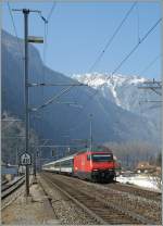The SBB Re 460 061-5 is arriving with an IR at Martigny Station.