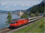 The SBB Re 460 036-7 with an IR to Brig by the Castle of Chillon.