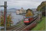 A SBB Re 460 with an IR 90 by the Castle of Chillon.