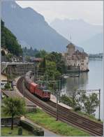 The SBB Re 620 017-4 with the Novelis Cargo train by the Castle of Chillon.