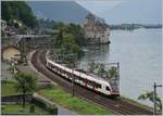A SBB Flirt on the way to Lausanne by the Castle of Chillon.