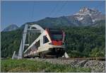 The SBB RABe 523 023 on the way to St-Maurice by the nwe rhone-Bridge near Massogex.