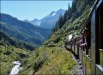 A DFB Steam train is running along the young Rhone on ist way from Gletsch to Oberwald on September 16th, 2012.