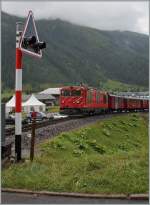 The MGB Gm 4/4 with a DFB Special Service is leaving Oberwald.