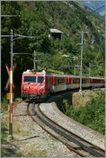 The MGB  Mattherhorn Gotthard Bahn  HGe 4/4 is on the way to Brig. Pictured by Stalden, the 22. 07.2012