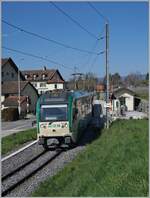 A BAM MBC local train on the way from Biere to Morges is leaving the Vuffelns le Château Station.