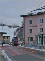 The TPF local train with the Be 4/4 121, B 207, B209 and ABt 221 on the way to Bulle in the streets of Montbovon.
