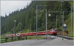 The RhB Fast train 1149 from Chur to St Moritz with Glacier Express 902 Part from Zermatt is arriving at Bergün Bravuogn.