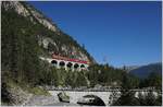 A RhB Ge 6/6 II wiht an Albula Fast Train service to St Moritz on Rugnux Bridge between Muot and Preda.