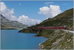 A RhB Bernina local train by the Lago Bianco (Withe Lake) between Bernina Ospizio and Alp Grüm.