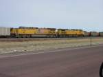 Union Pacific UP 1266 & 5958 pull an empty coal train past a full train near Bill, Wyoming on 10 Nov 2003.