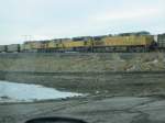 Union Pacific With miles and miles of staging track, 4 and 5 wide, Bill, Wyoming has more empty coal cars than almost any place on the planet. Here UP 7120 and two other loks pull a loaded coal train past the miles of empties.