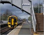 The ScotRail Class 158 (158 735) to Edinburgh is arriving at Dalmeny.