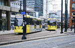 Manchester Metrolink Trams 3024 and 3096 (Bombardier M 5000) crossing Portland Street near the station Piccadilly Gardens.
