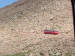 A single car labors up the hill toward Pikes Peak, Colorado. 8 June 2003.