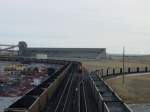 Various Two trains are being loaded, one BNSF, one UP, while another UP heads off on the staging track to the right. Thunder Basin Coal Co. near Wright, Wyoming 10 Nov 2003.