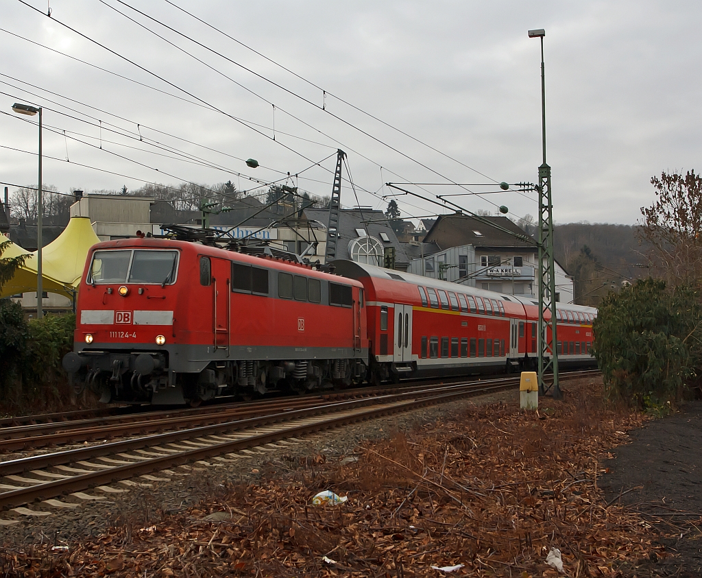 111 124-4 with RE 9 (Rhein-Sieg-Express) Aachen - Cologne - Siegen, leaving here on 11.12.2011 at the station  Betzdorf/Sieg and continue towards Siegen.