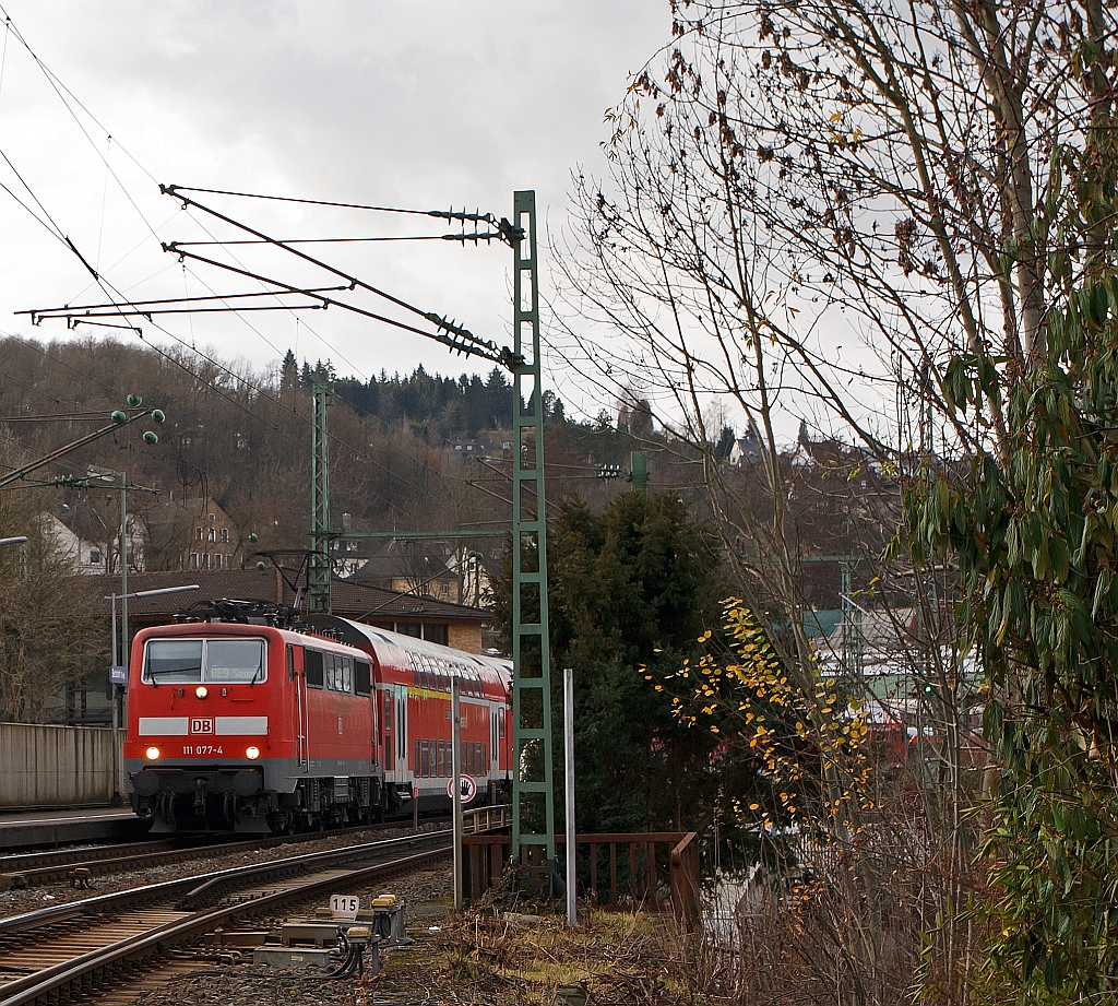 111077-4 with RE 9 (Rhein-Sieg-Express) Aachen - Cologne - Siegen, on 10.12.2011, leaving here the station  Betzdorf/Sieg and continue towards Siegen.