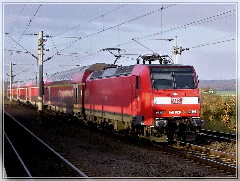 146 028-6 is running with bi-level cars through the station Kln-Weiden West on November 6th, 2007.