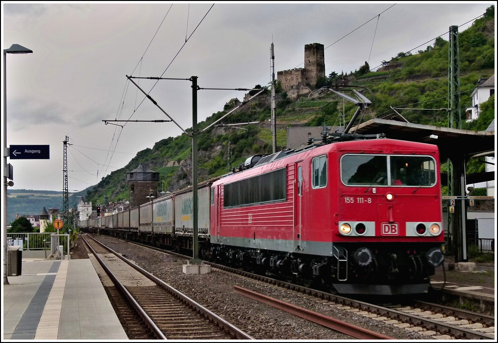 155 111-8 is hauling a freight train through the station of Kaub on June 25th, 2011.