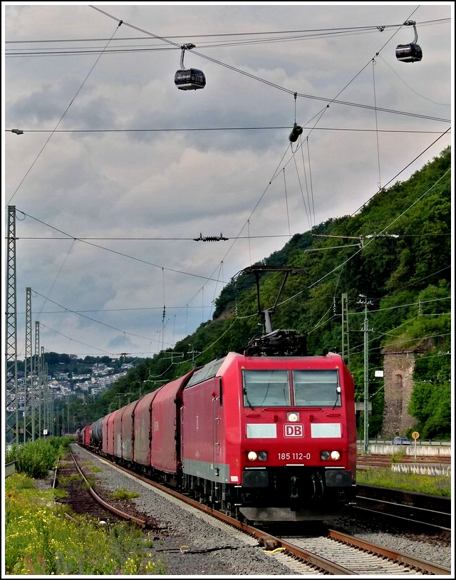 185 112-0 is hauling a goods train through the station Koblenz-Ehrenbreitstein on June 24th, 2011.