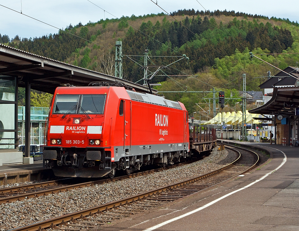 185 303-5 of the DB Schenker Rail runs on 30.04.2012 with a mixed freight train through the station Betzdorf/Sieg in the direction of Cologne.
