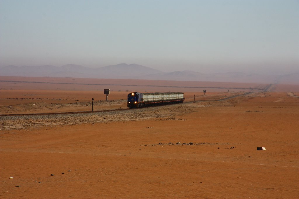 30 minutes before, I saw this train as a small light on the horizon at the virtual end of this long stretch of railroad through the desert.

Perurail 751 with a train of containers full of acid liquids for the mines.
Near La Joya