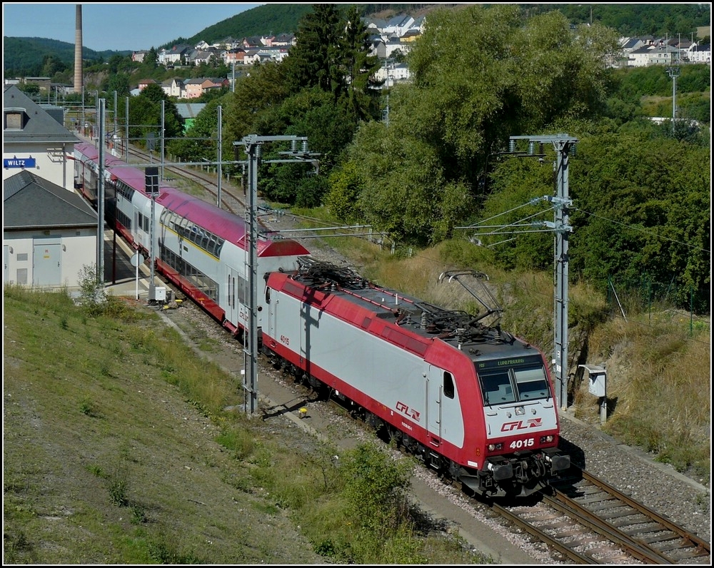 4015 with bilevel cars is leaving the station of Wiltz on August 7th, 2010.