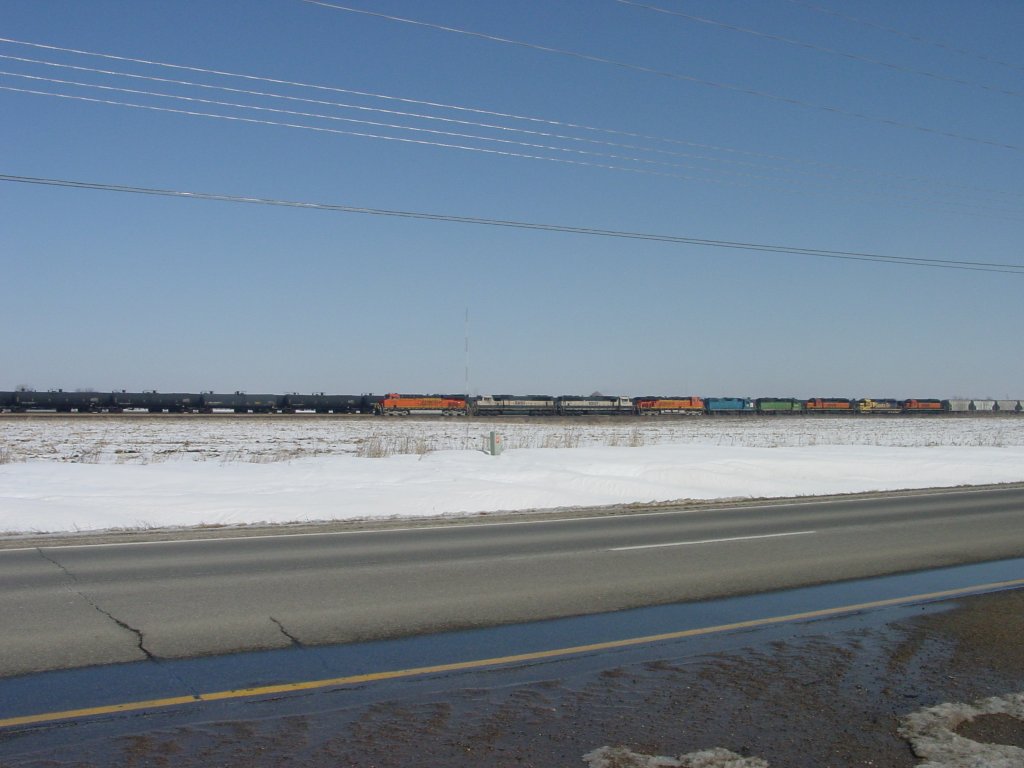 9 lok train is finally picking up speed after climbing the hill out of the Mississippi River valley. It is pulling a very long train, many cars over the one mile limit, but with work being done on the Mississippi River bridge, the trains are longer and bunched together so workers can work for longer periods of time. 3 Mar 2010