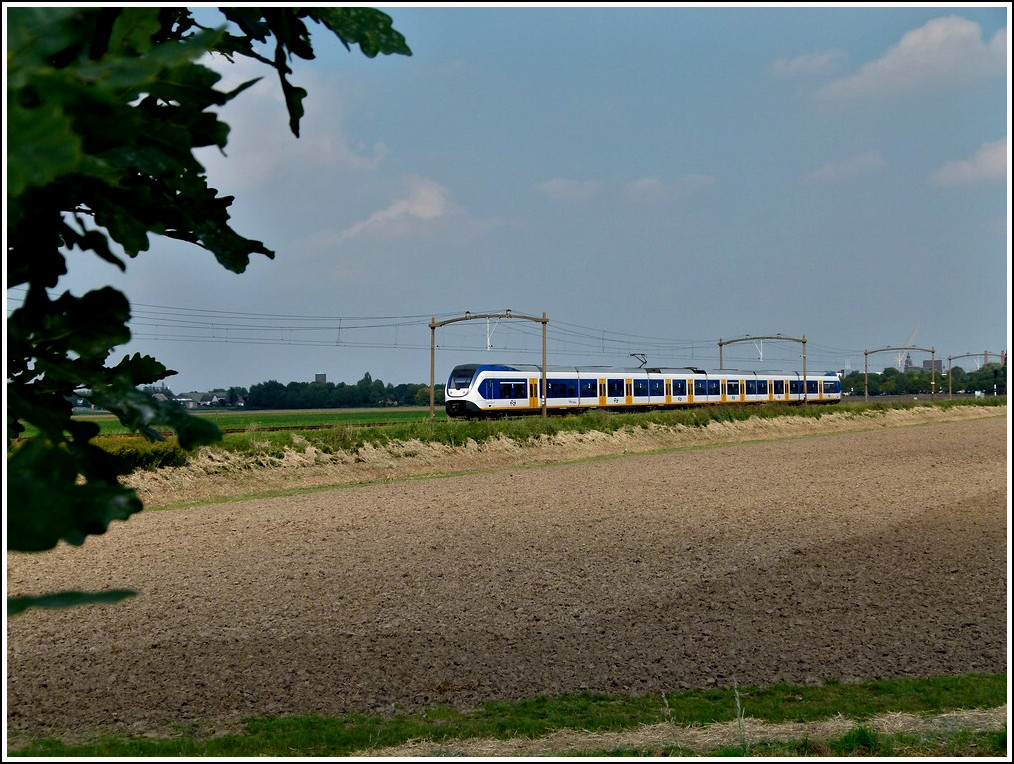A 2400/2600 Sprinter Lighttrain is running between Oudenbosch and Zevenbergen on September 3rd, 2011.