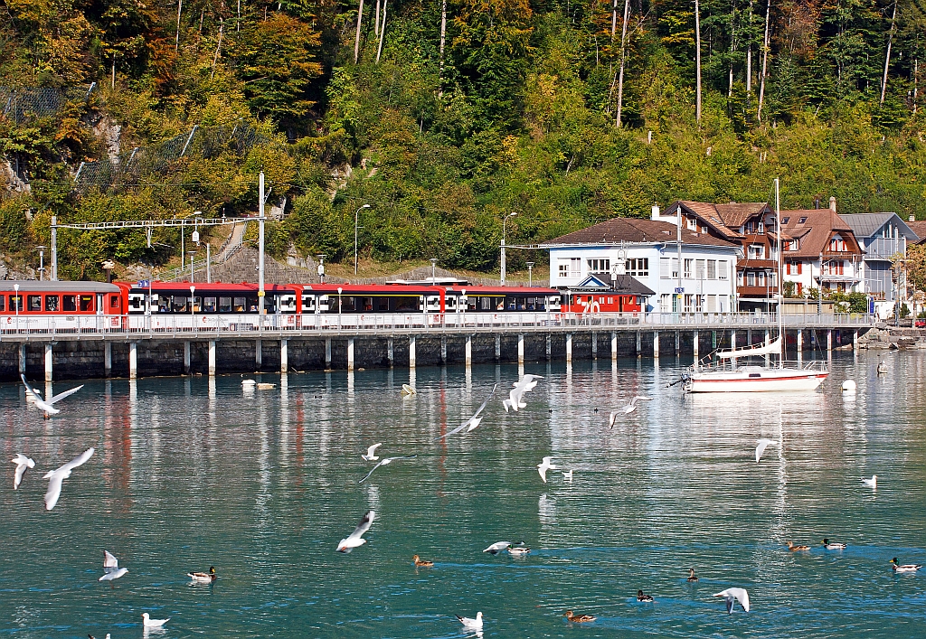 A Baggage railcar De 110 of the Zentralbahn with an IR (Interlaken - Lucerne) on 30.09.2011 at Brienz station.