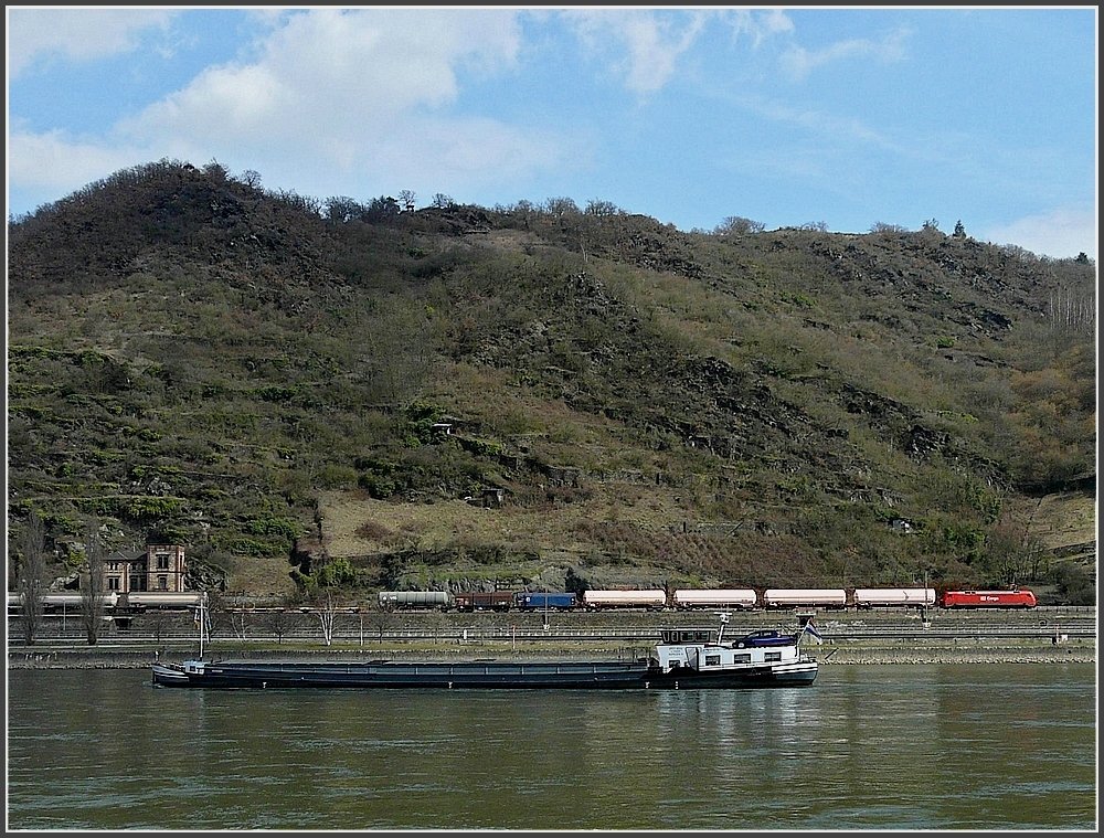 A goods train is meeting a ship while running through the Rhine gorge near Loreley rock on March 19th, 2010.