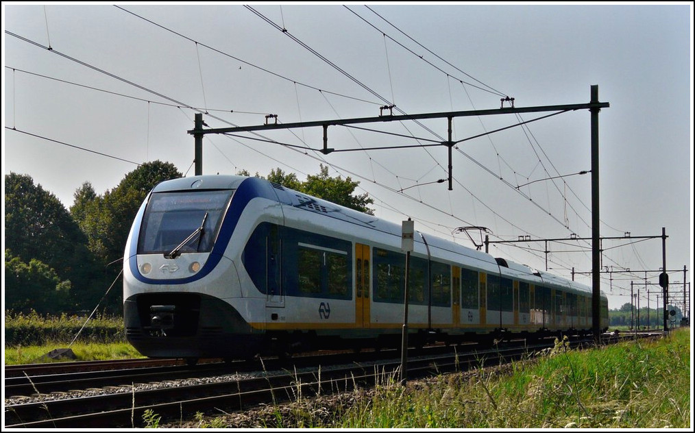 A local train from Roosendaal to Dordrecht is running through Oudembosch on September 3rd, 2011.