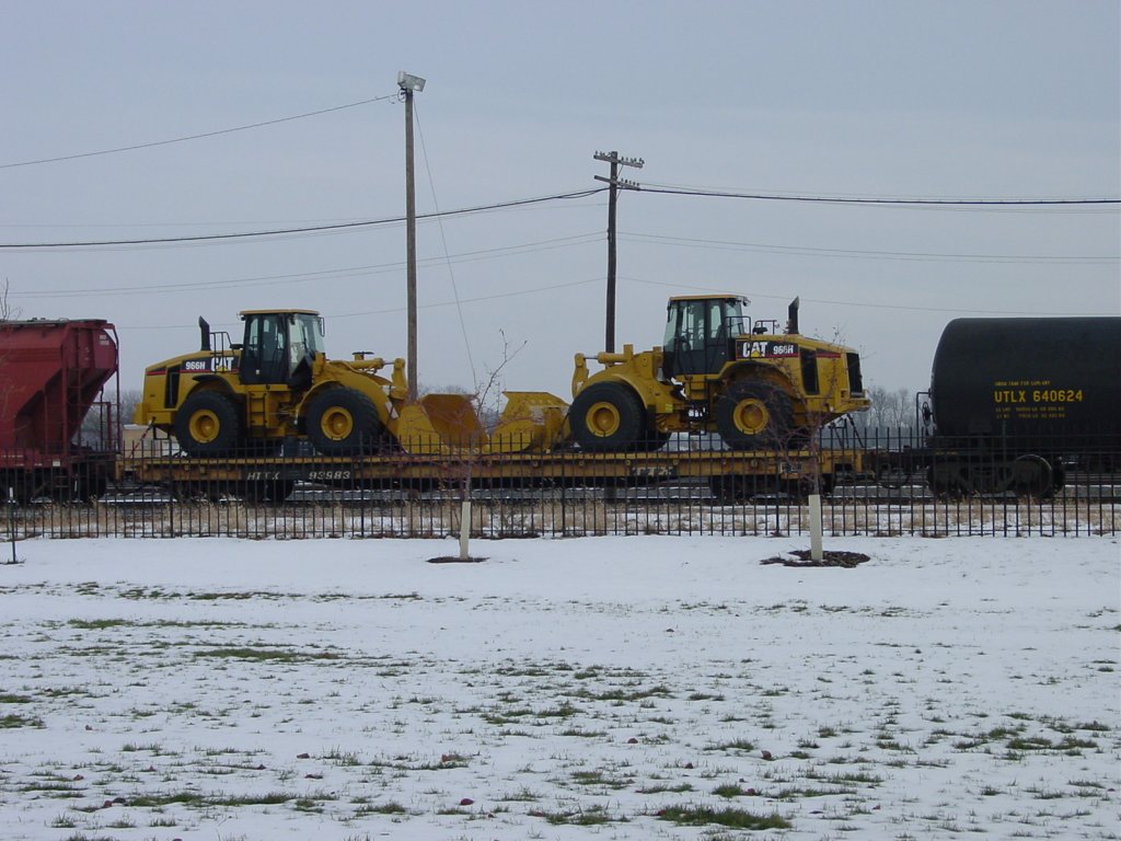 A pair of Caterpillar end loaders are riding high thru the yard at Burlington, Iowa. They are produced in Illinois and these are heading west. 13 Dec 2005.