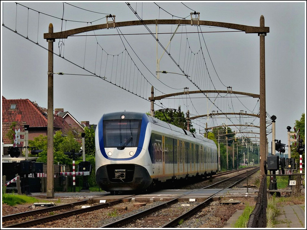 A Stoptrain from Den Haag to Roosendaal is entering into the station of Oudenbosch on September 3rd, 2011.