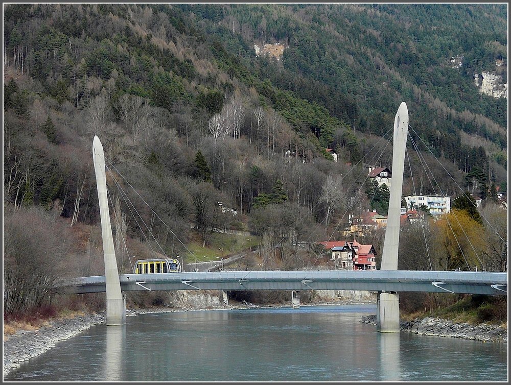 A train of the Hungerburgbahn is crossing the Inn bridge at Innsbruck on December 22nd, 2009.