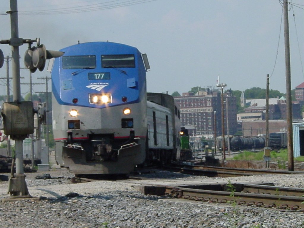 Amtrak 177 pulls its train from the westbound track onto the eastbound track at the South Street crossing in Burlington, Iowa. You can clearly see the difference in height of the old baggage cars and the new Amtrak passenger cars in this view. The reason the lower lights seem to change in intensity is that they flash back and forth when the horn sounds. 