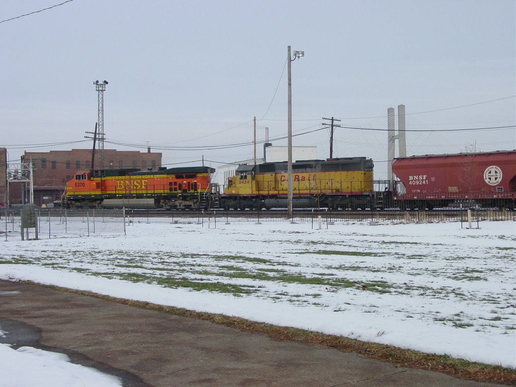 BNSF 5370 & Canadian Pacific 5424 pull a mixed freight thru the Burlington, Iowa yard and are about to cross Main Street. 13 Dec 2005.