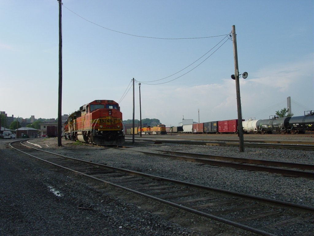 Burlington, Iowa yard during its annual carnival called  Steamboat Days  with a ferris wheel in the background. Various BNSF diesels sit in several places. 11 June 2005.