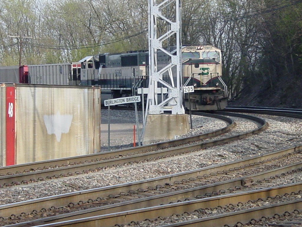 Burlington Northern 9709 & 9689 (SD70MACs) round the curve coming off the Mississippi River bridge and are about to pass mile marker 205 (miles from Chicago) on 9 Apr 2005.