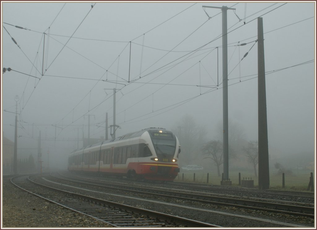 By a heavy fog is entering in the Noiraigue station the TRN local train to Buttes. 
07.12.2009