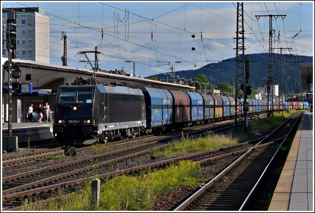 CFL Cargo 185 574-1 is hauling a goods train through the main station of Koblenz on June 23rd, 2011.
