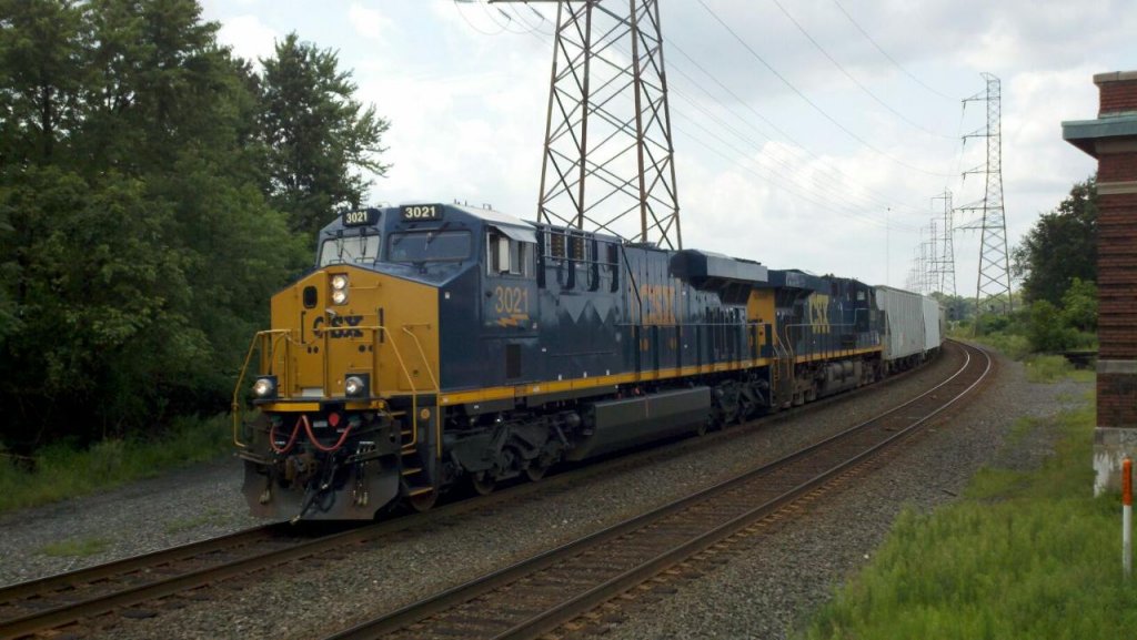 CSX Q438 pass bound brook with a shiny new csx boxer logo engine leading.